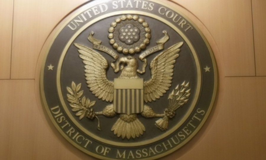 United States Court District of Massachusetts seal on a wood-paneled wall