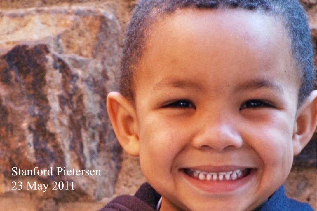 A young boy is smiling in a photo taken on may 23 2011