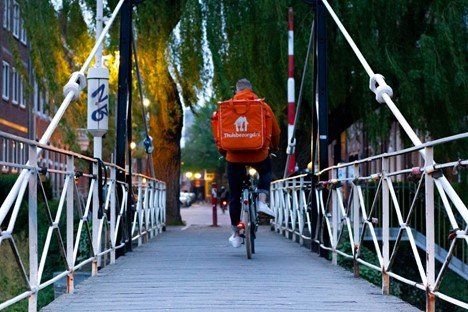 A delivery guy out to deliver food to a customer
