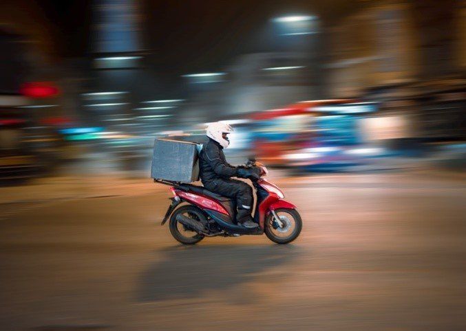 a delivery guy on a bike