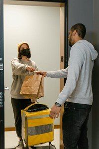 a female rider delivering food to a man