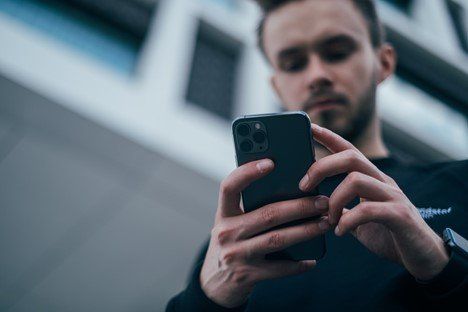 A man using his phone to order from a restaurant online