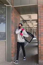 a man carrying a thermal food delivery bag