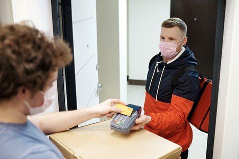 A man is paying for food delivery with a credit card