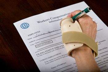 A calculator sits on top of a workers compensation claim form — Willmar, MN — Schneider & Madsen PC A calculator sits on top of a workers compensation claim form — Willmar, MN — Schneider & Madsen PC