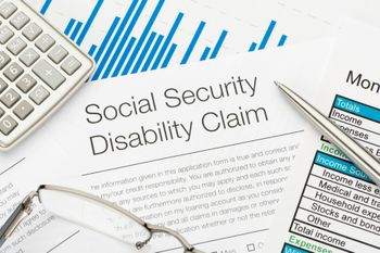 A social security disability claim form with a pen and calculator — Willmar, MN — Schneider & Madsen PC A social security disability claim form with a pen and calculator — Willmar, MN — Schneider & Madsen PC