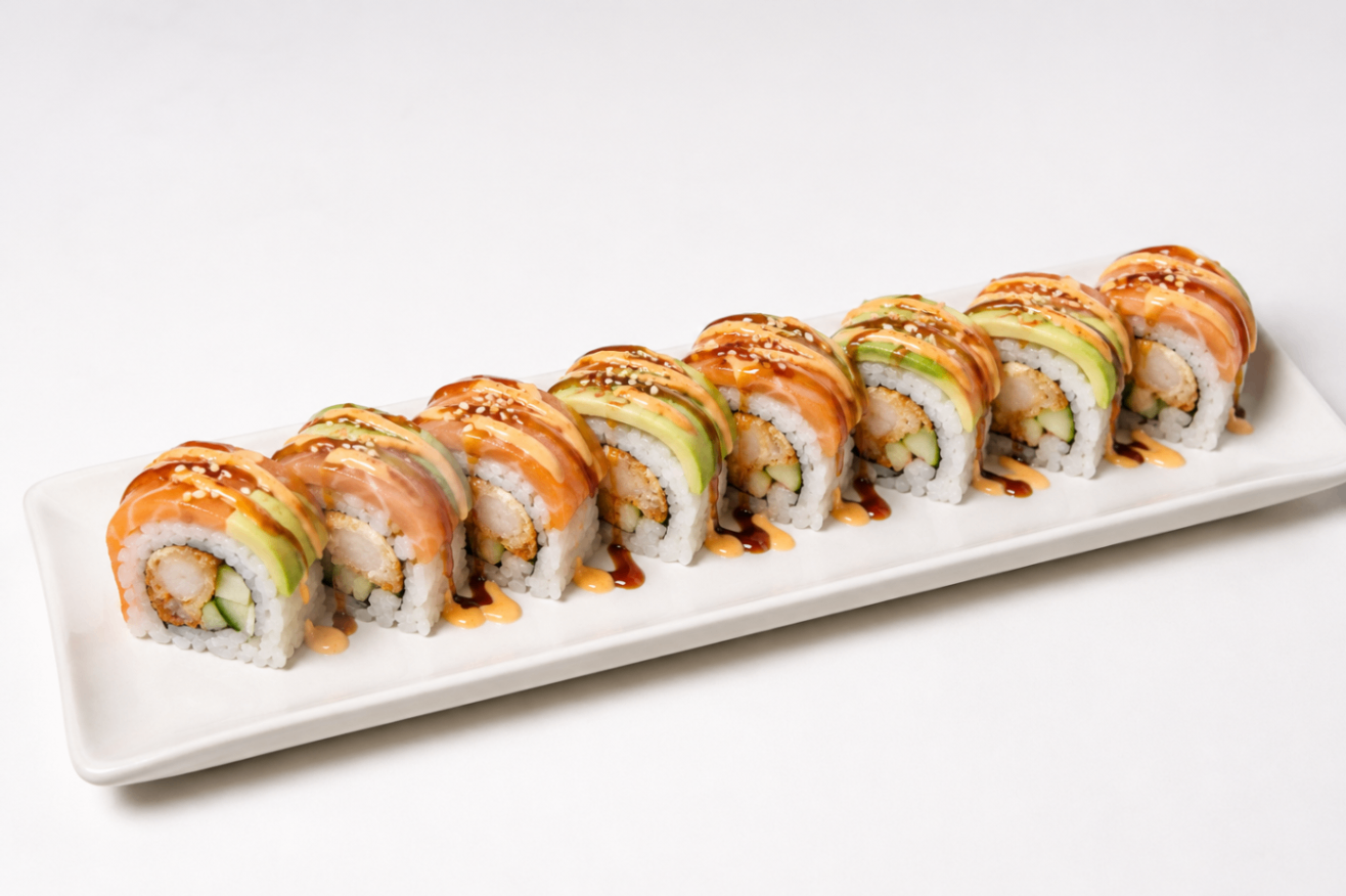 Assorted sushi rolls with orange sauce on a white rectangular platter