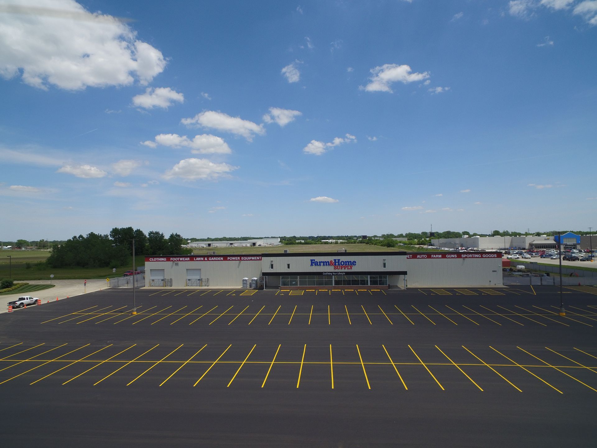Exterior view of a Per Mar security building with a large empty parking lot on a sunny day.