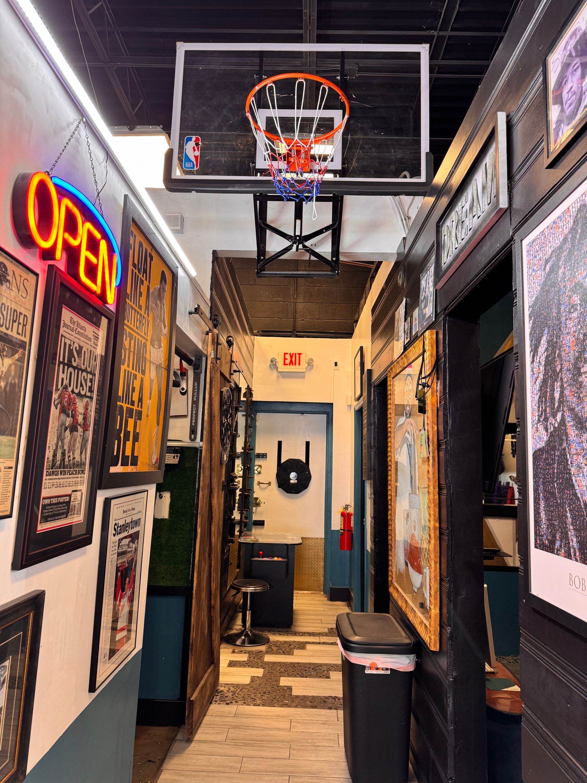 A hallway with a basketball hoop hanging from the ceiling.