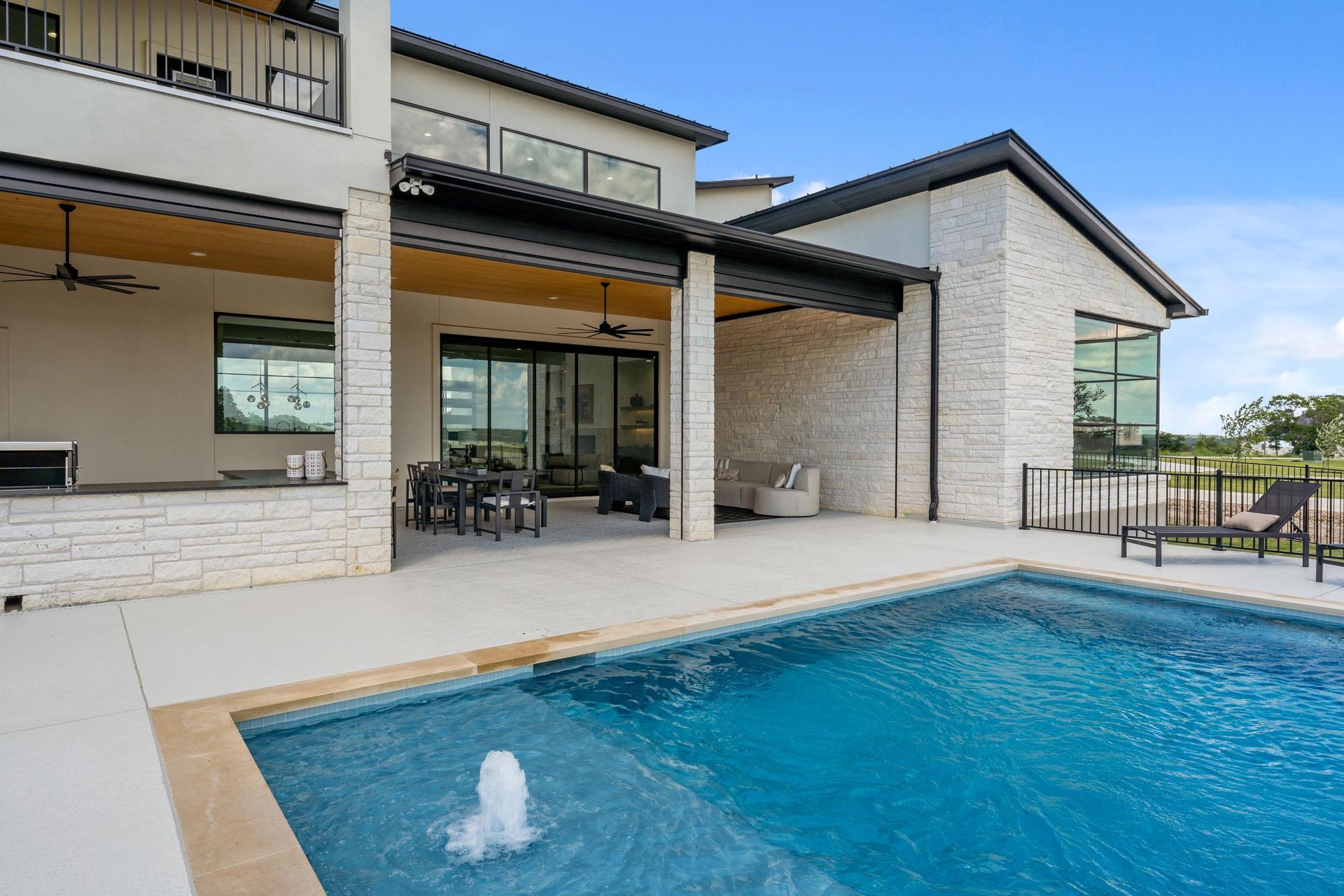 Modern house with patio and swimming pool with fountain