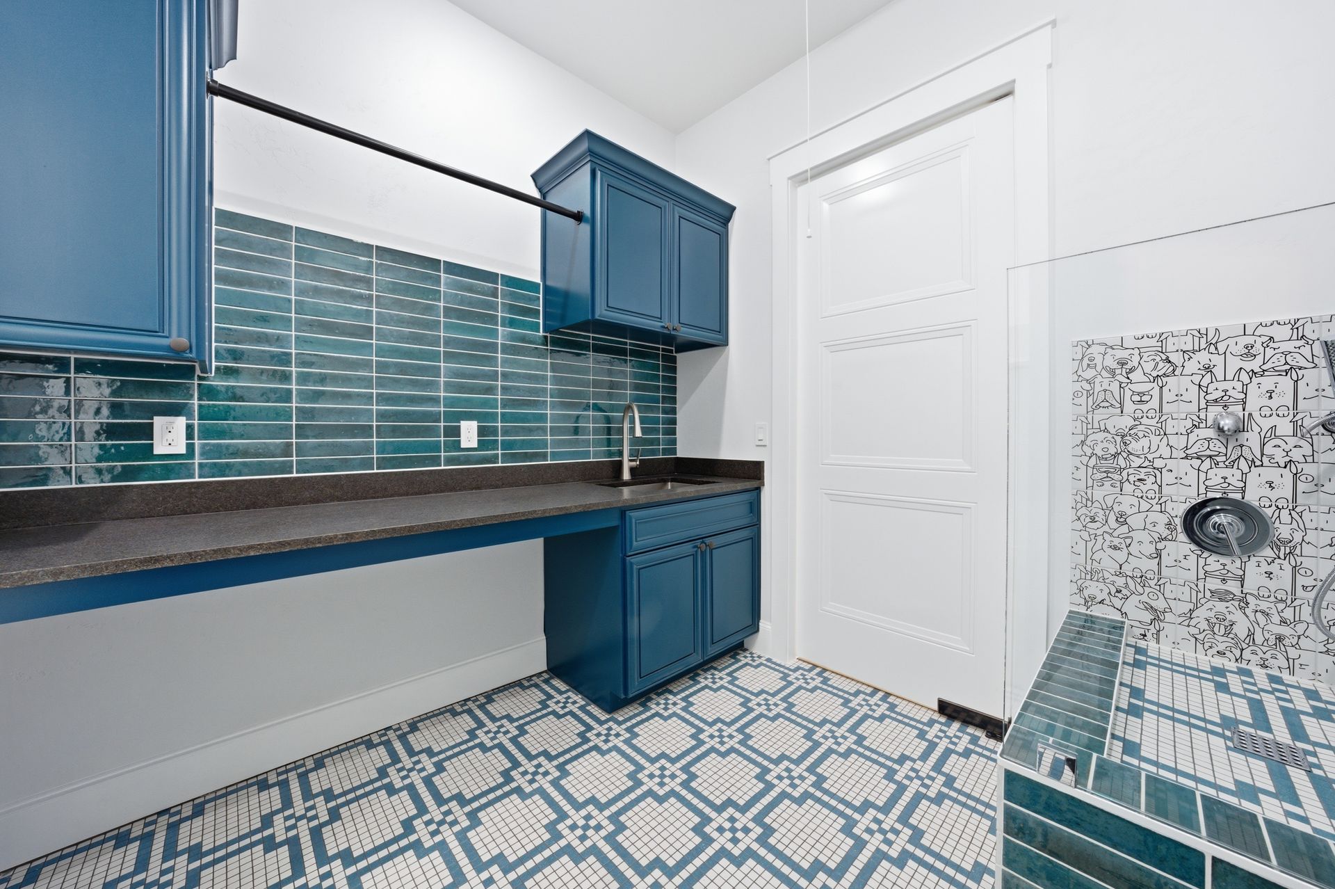 Blue-and-white bathroom with patterned tile floor, vanity, mirror, and glass shower enclosure