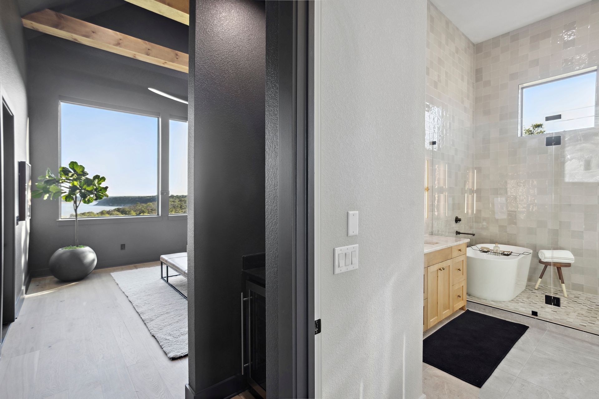 Bright modern room with large window beside a small bathroom with toilet and vanity