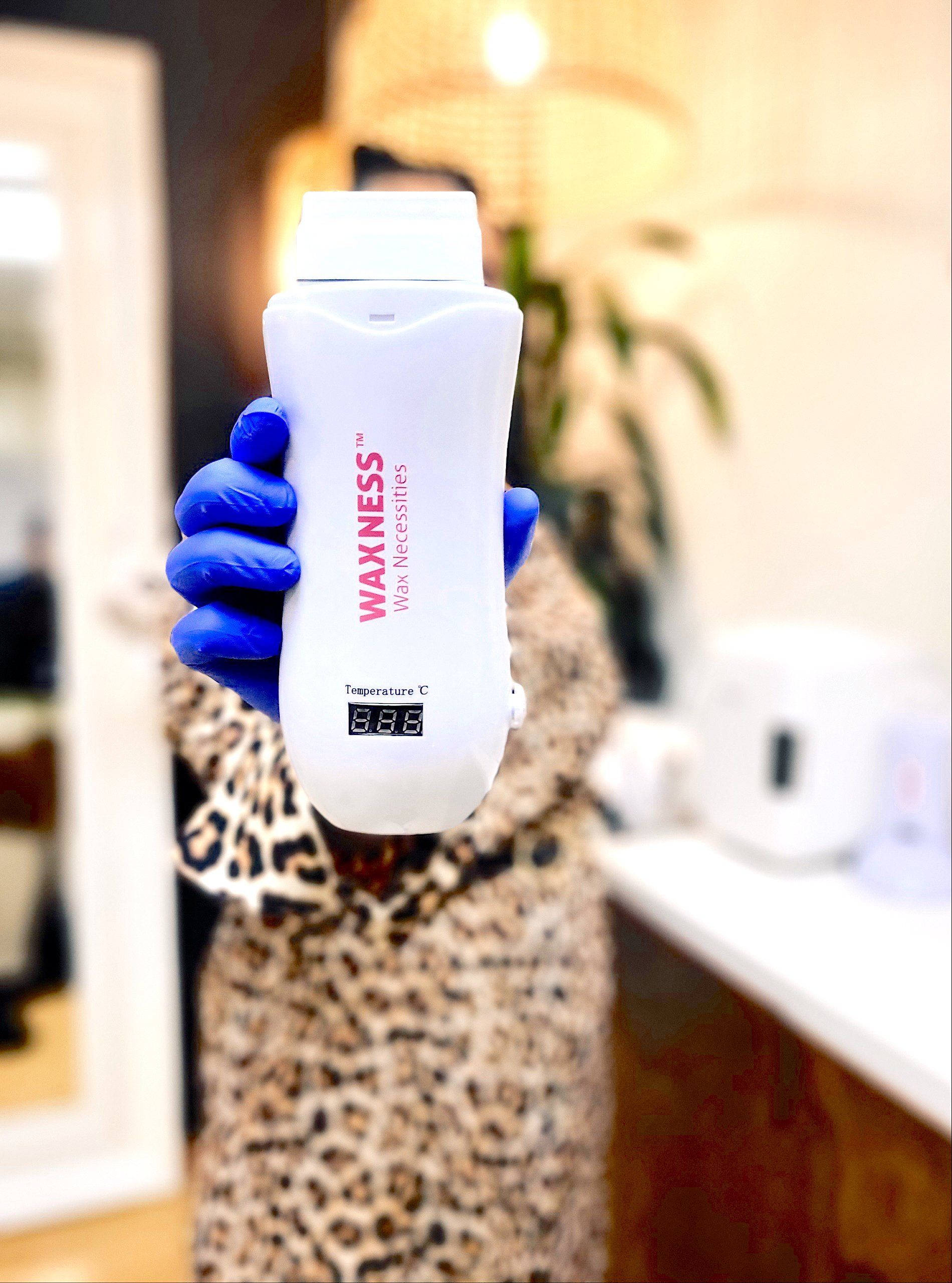 A woman in a leopard print coat is holding a bottle of wellness