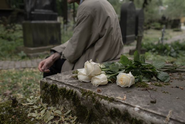 Fresh flowers placed on a gravesite at a peaceful cemetery in honoring a loved one with care and remembrance
