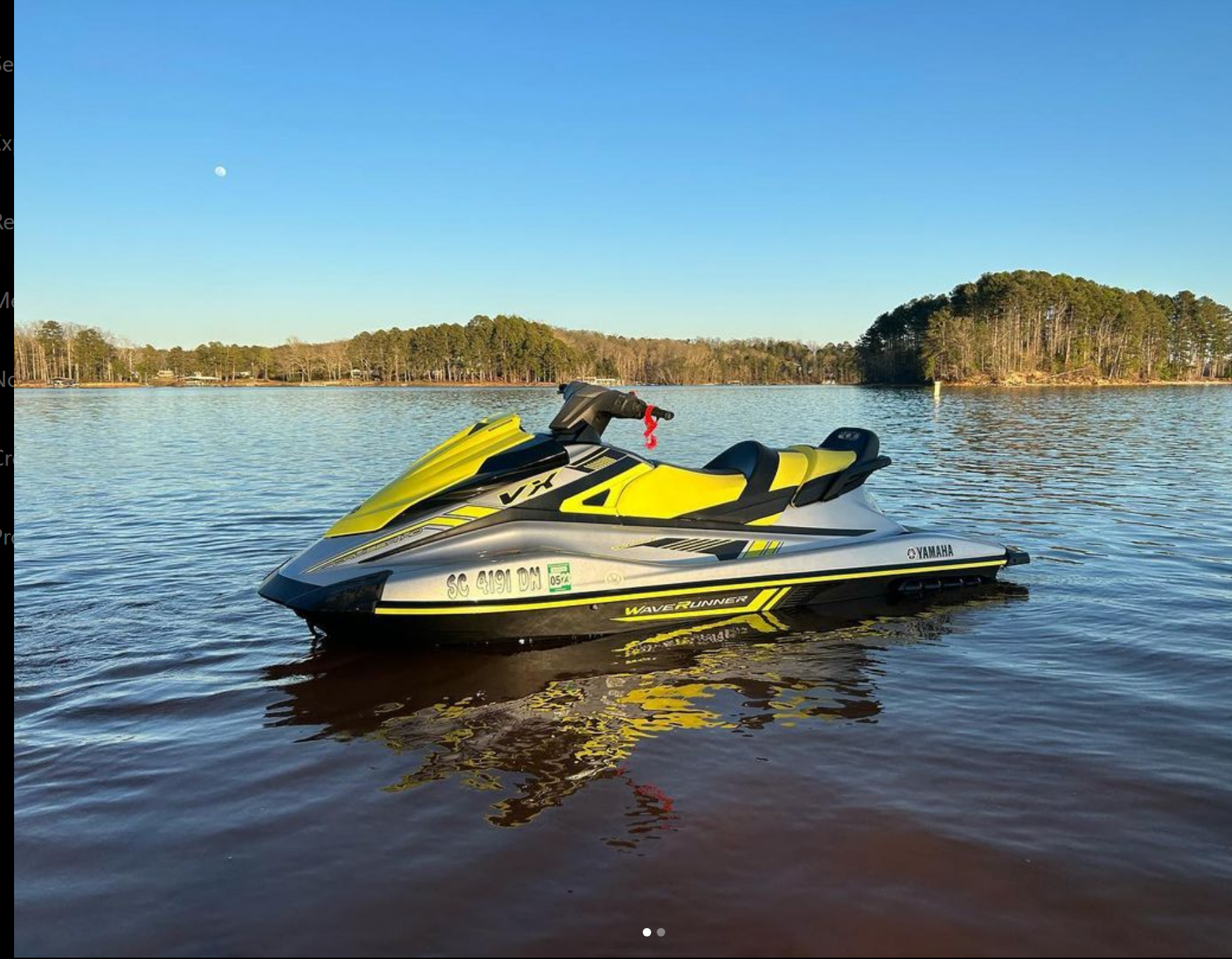 A yellow and black jet ski rental floating on top of Lake Hartwell