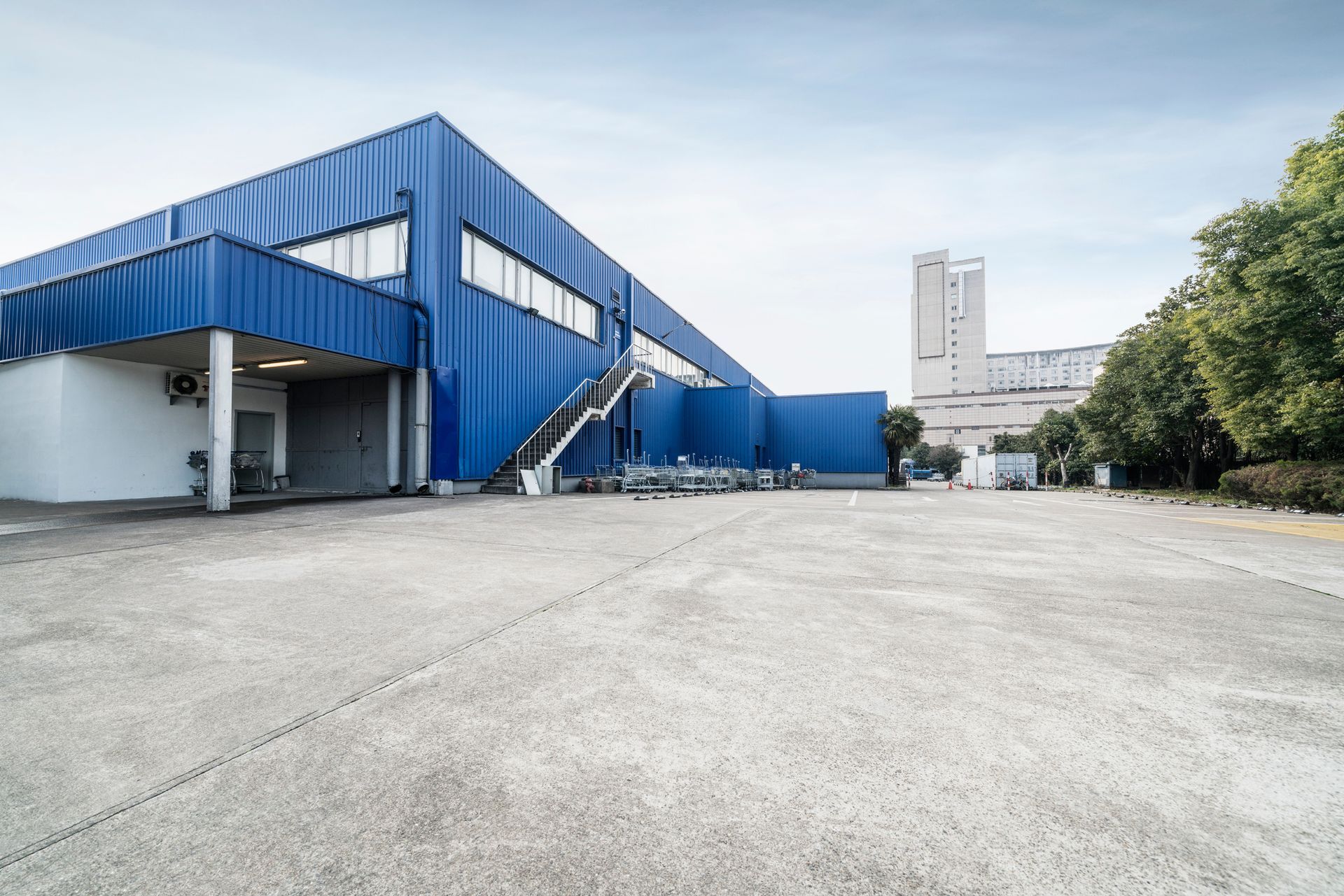 A large blue and white building with stairs leading up to it.
