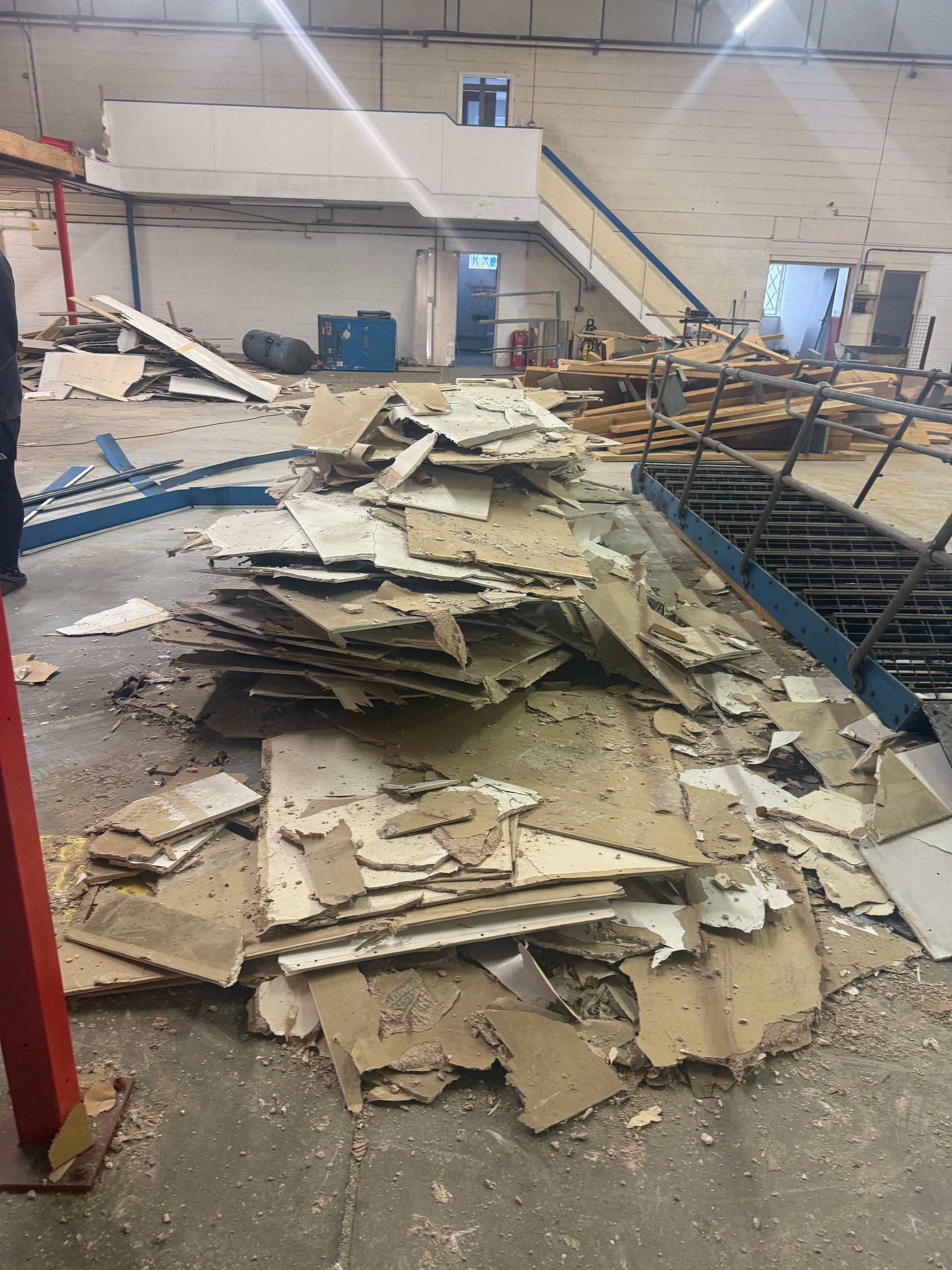Commercial plasterboard waste ready for collection from a warehouse strip out