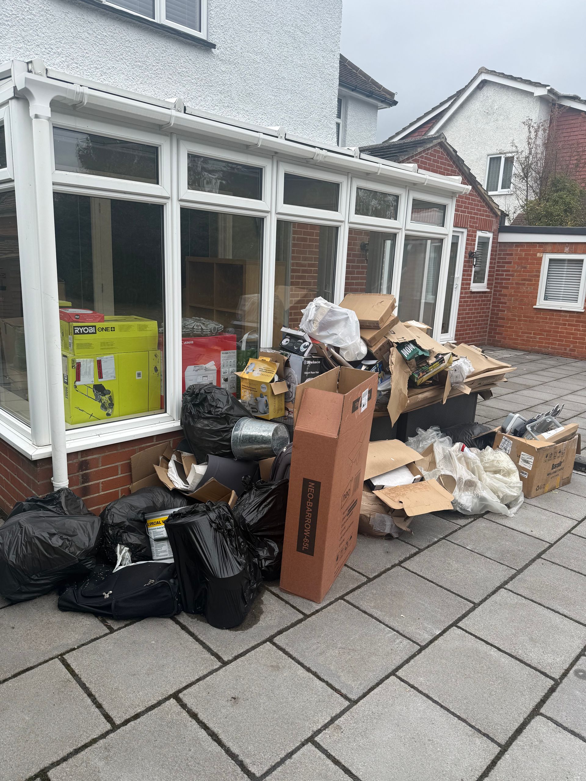 Household items and rubbish outside a property in Spencers Wood before collection