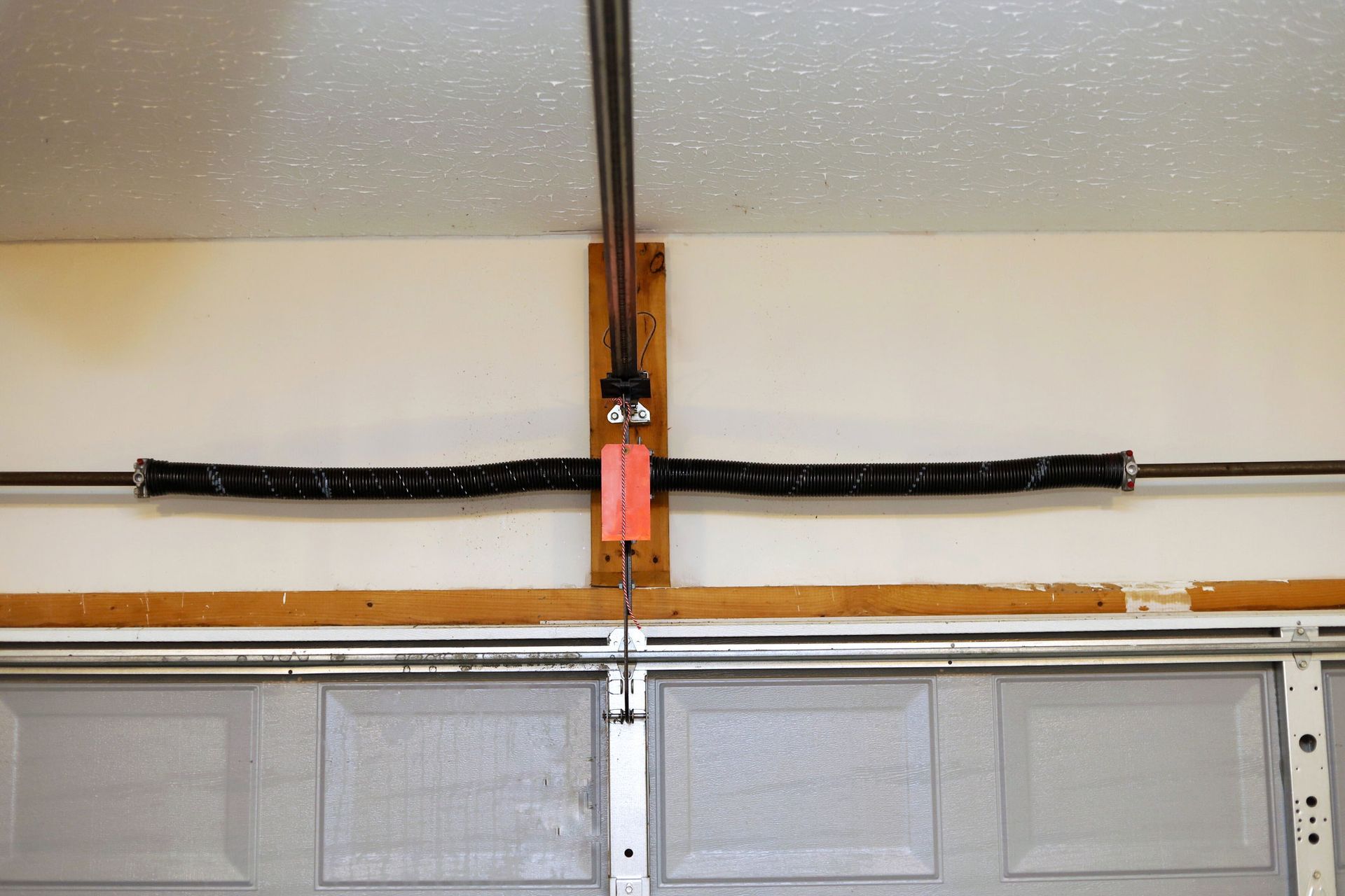 A garage door with a spring attached to it