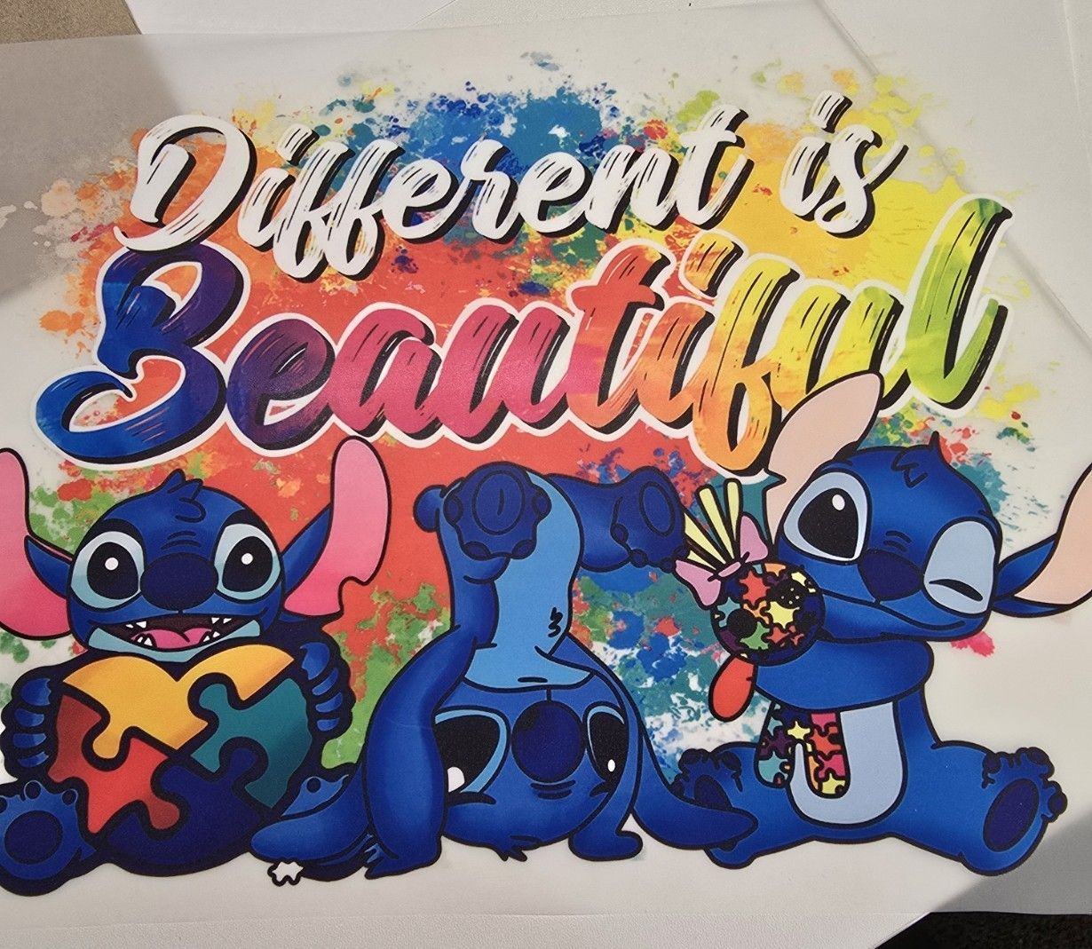Three Stitch characters with puzzle-themed items in front of a colorful splash background, reading 