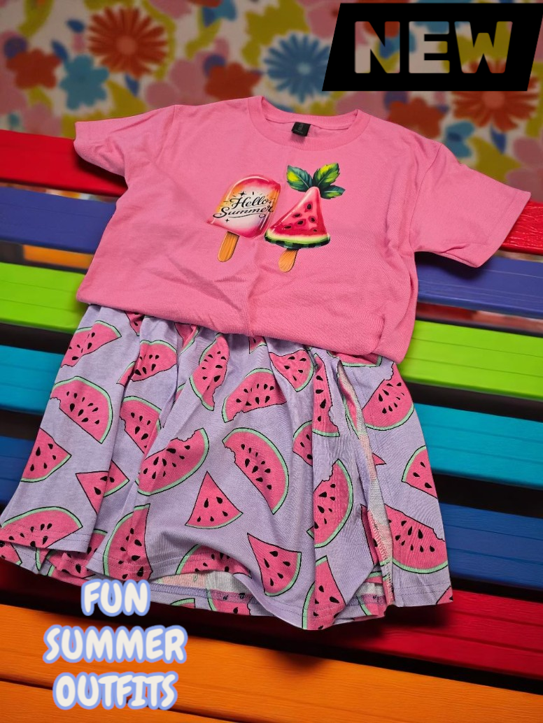 A pink t-shirt with ice pop graphics paired with a purple skirt featuring a watermelon print on a colorful slat bench.