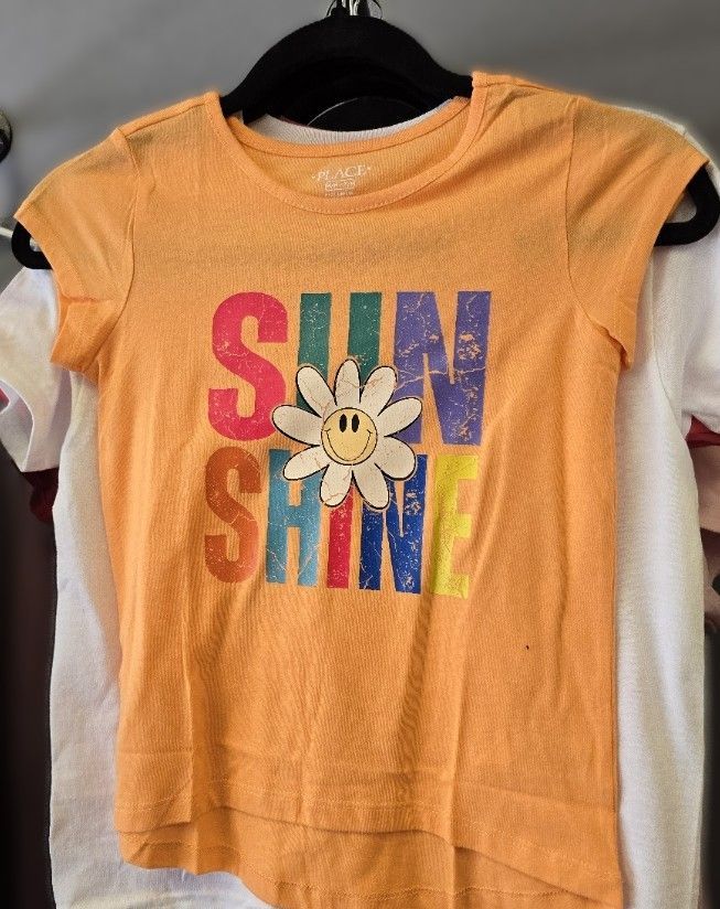 A bright orange short-sleeved t-shirt with the word 