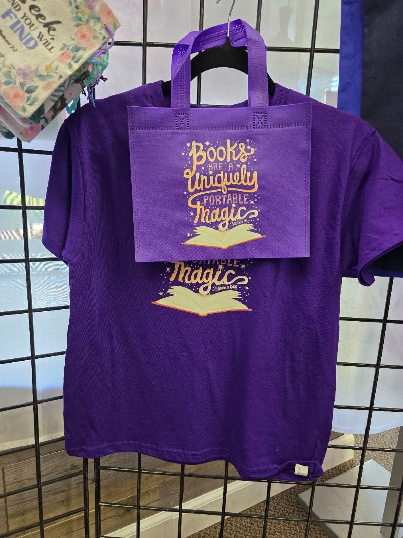 A purple T-shirt and matching small bag, both printed with 