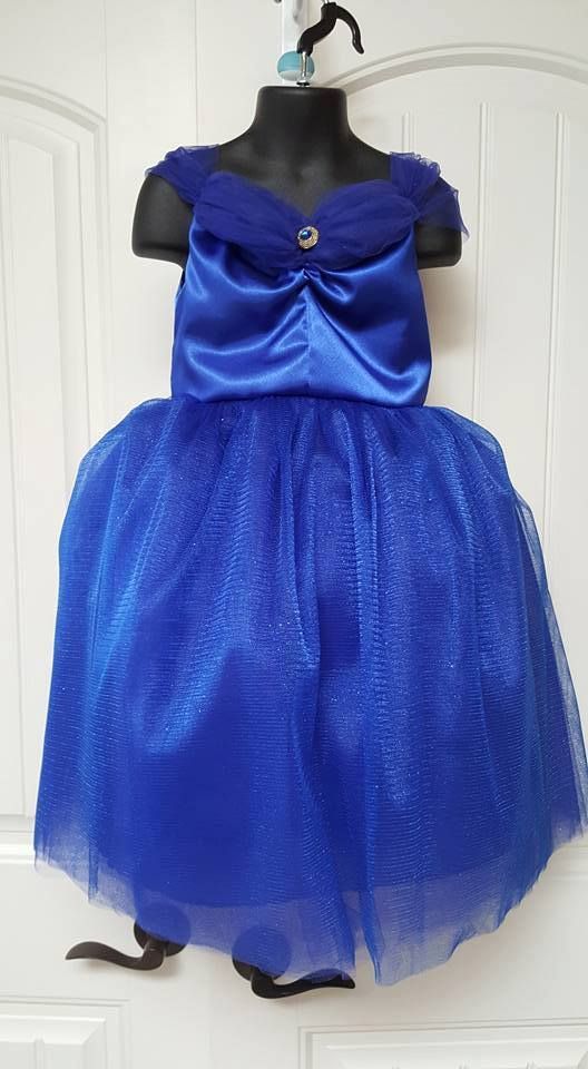 A royal blue satin dress with off-the-shoulder tulle sleeves and a full tulle skirt displayed on a black mannequin.