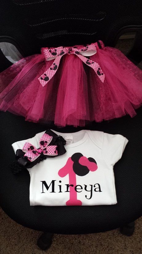 A Minnie Mouse-themed outfit with a pink tutu, a white onesie personalized with 