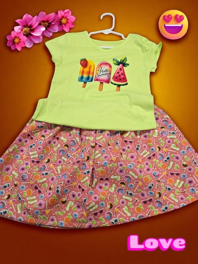 A lime green t-shirt with a popsicle graphic over a floral skirt with a pink background, accented with digital emojis.