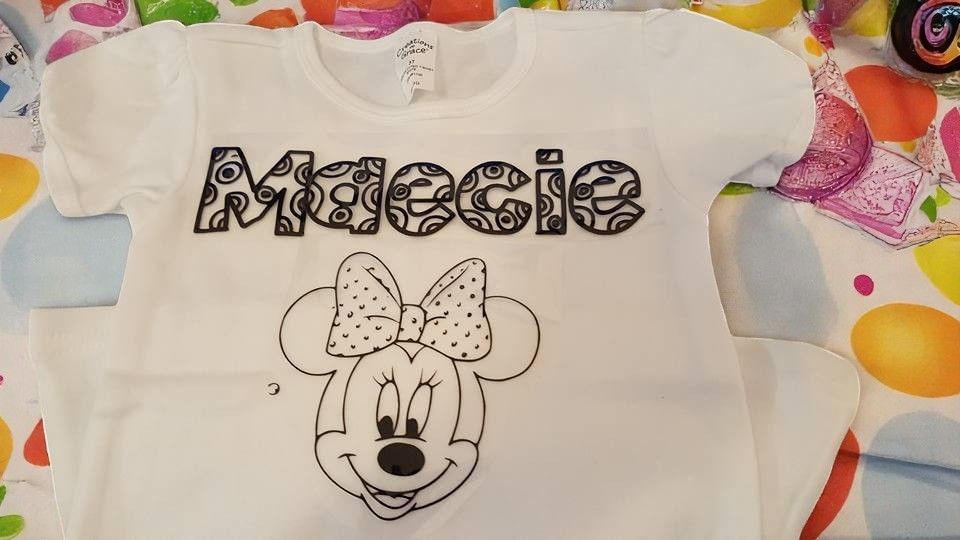 A white t-shirt featuring a black line drawing of Minnie Mouse and the name 