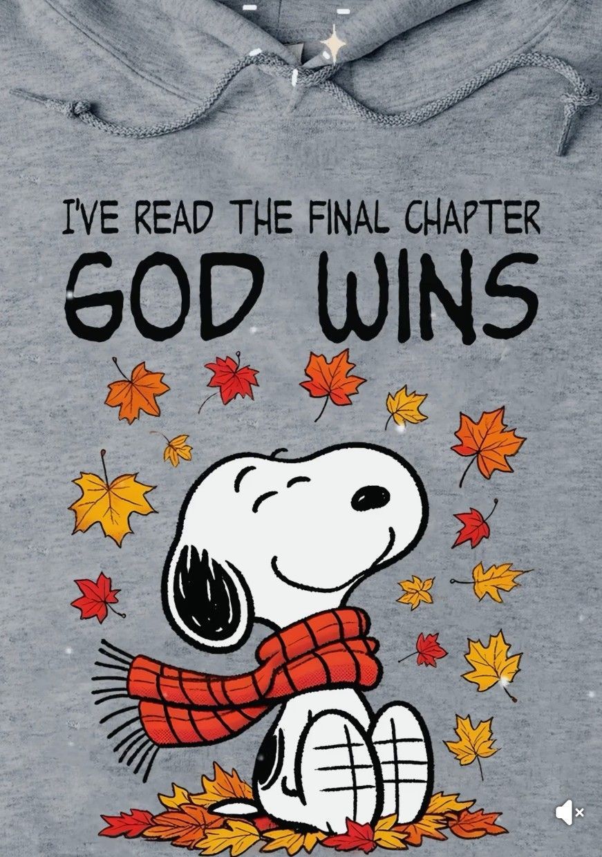 A gray hoodie with Snoopy wearing a red scarf amidst autumn leaves. Above him, the text reads, 