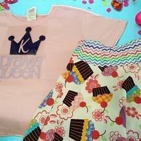 A pink t-shirt with a crown and 