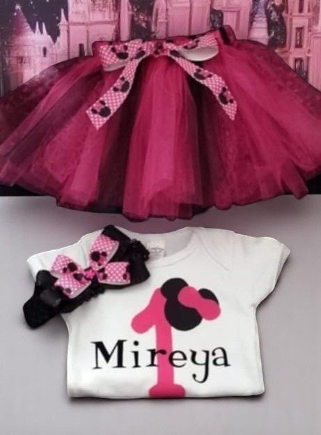 A white custom baby onesie featuring the name 