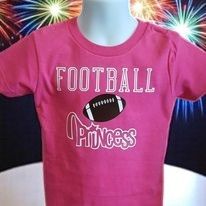 A pink short-sleeved t-shirt featuring the white text 