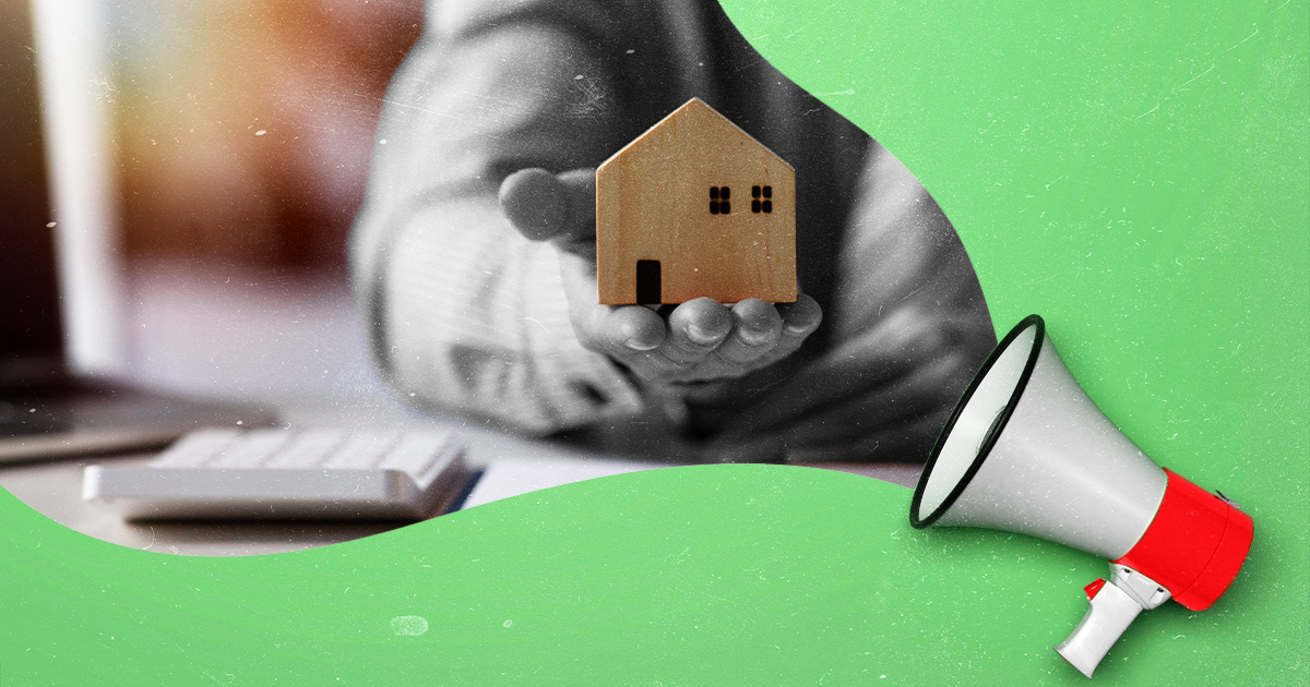 Hand holding a miniature house, with a megaphone on a green background, representing real estate or homeownership.