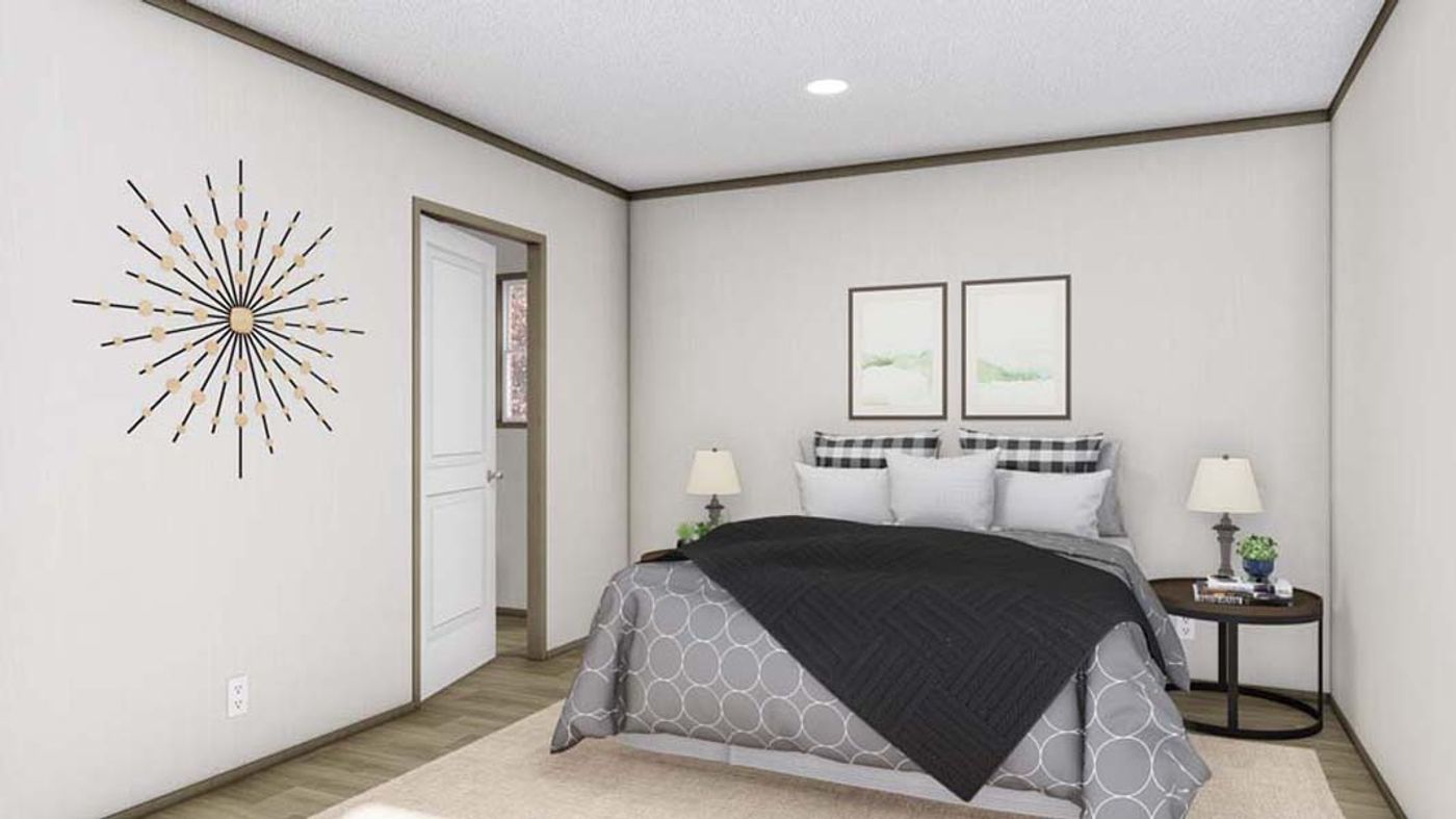 A bedroom with a bed and a clock on the wall.