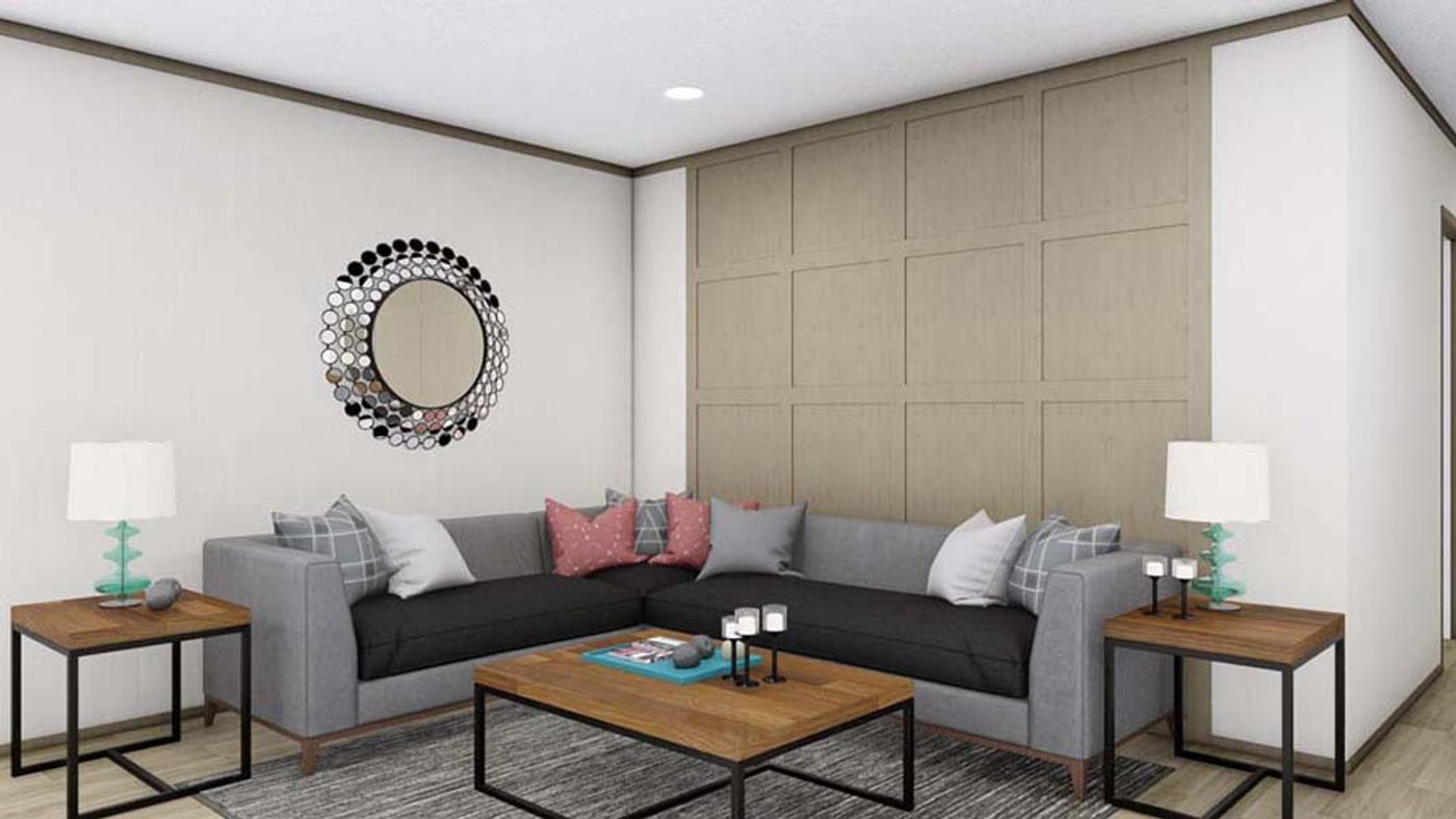 A living room with a couch , two coffee tables , and a mirror on the wall.