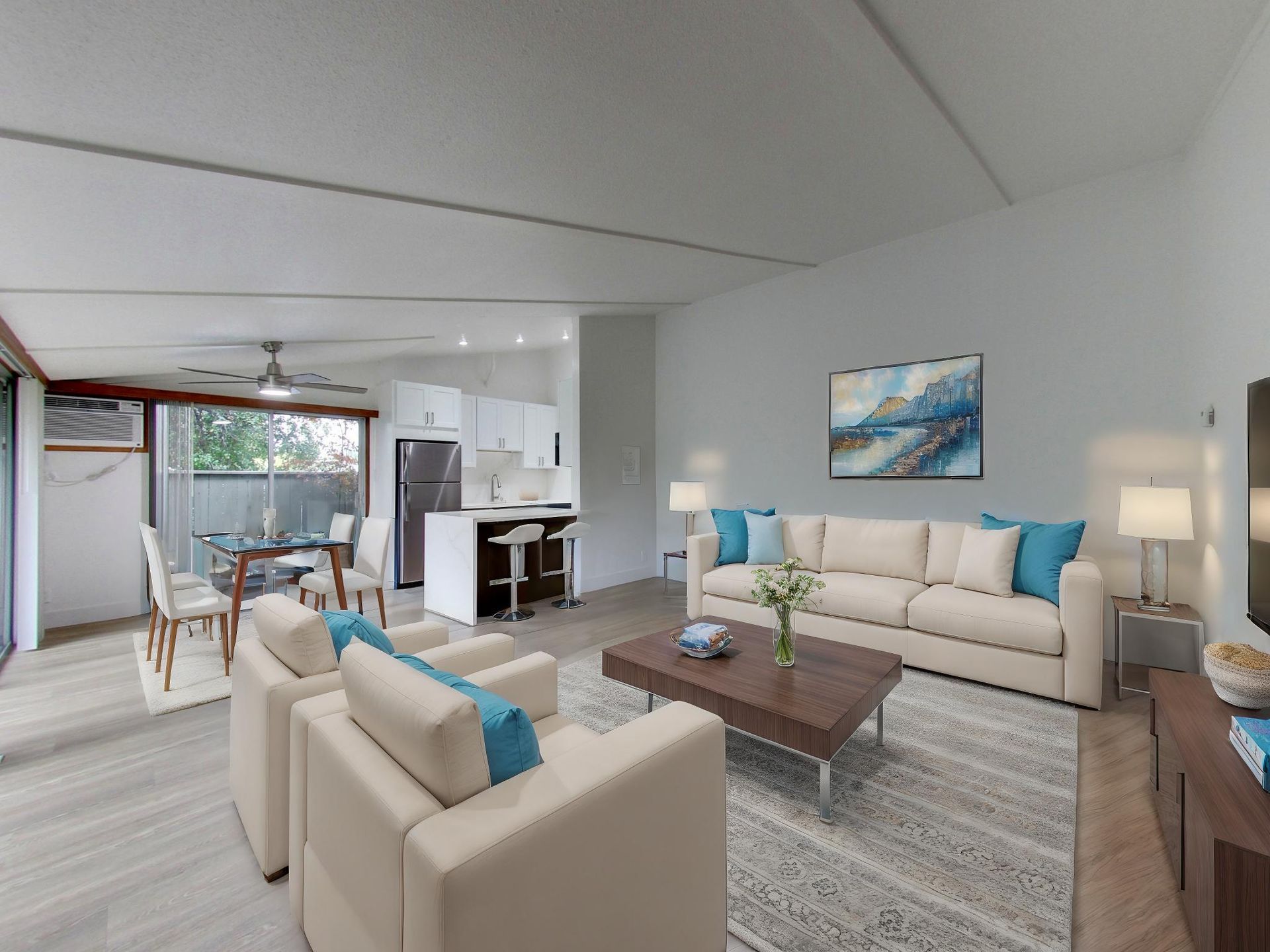 modern living room with a sofa, coffee table, bench, chair, tv and onlooking to a patio