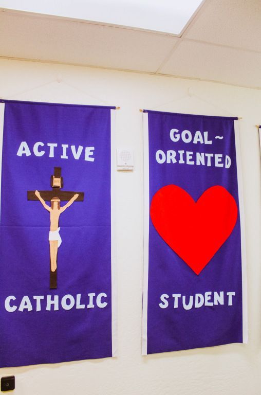 Two purple banners with a crucifix and red heart, reading “Active Catholic” and “Goal-Oriented Student.”