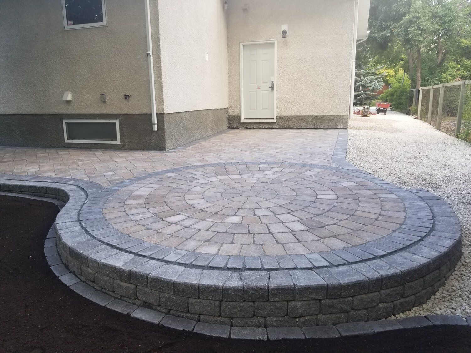 A house with a circular patio in front of it