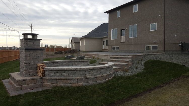 A large house with a patio and stairs in front of it