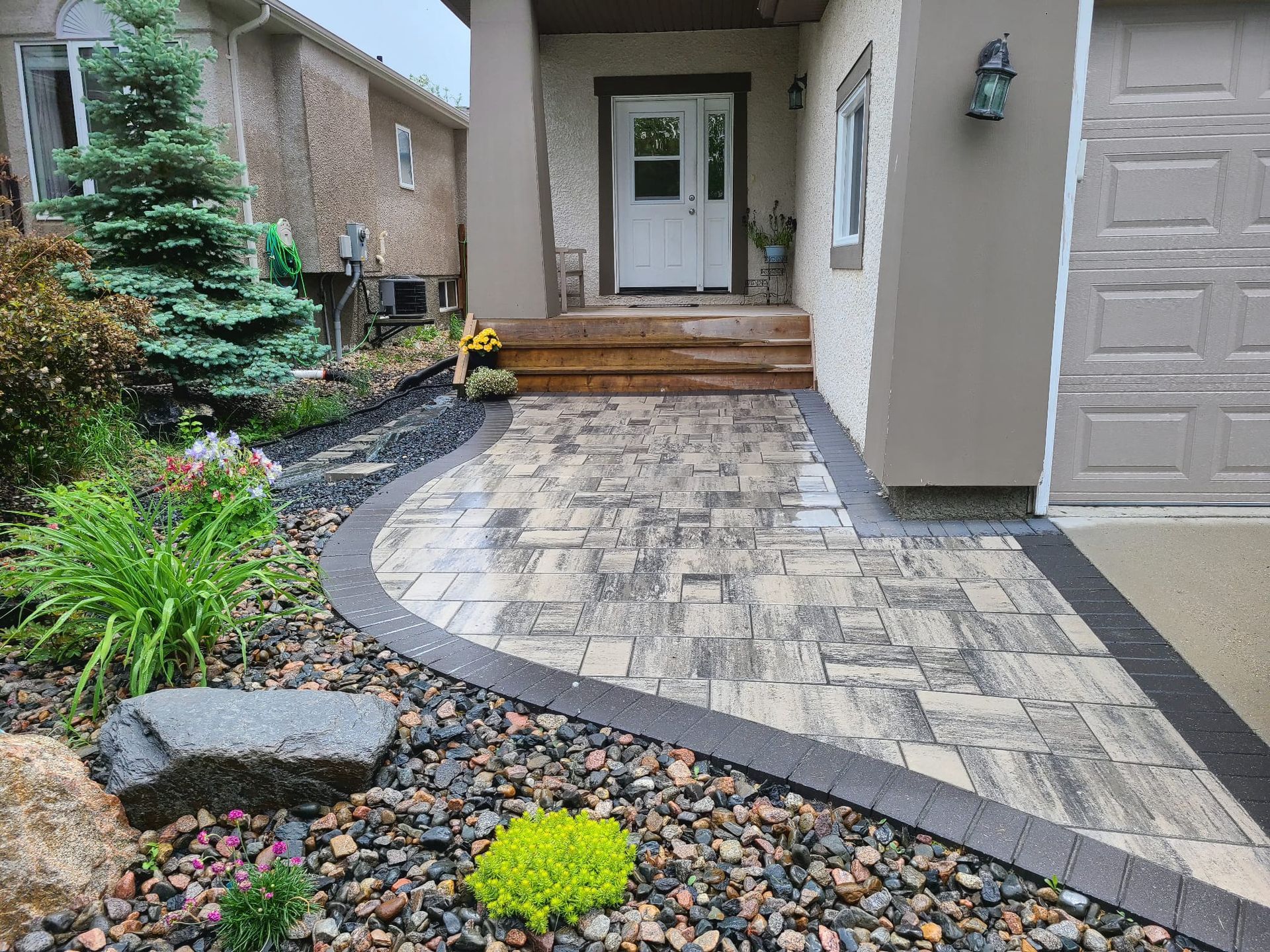 A stone walkway leading to the front door of a house.