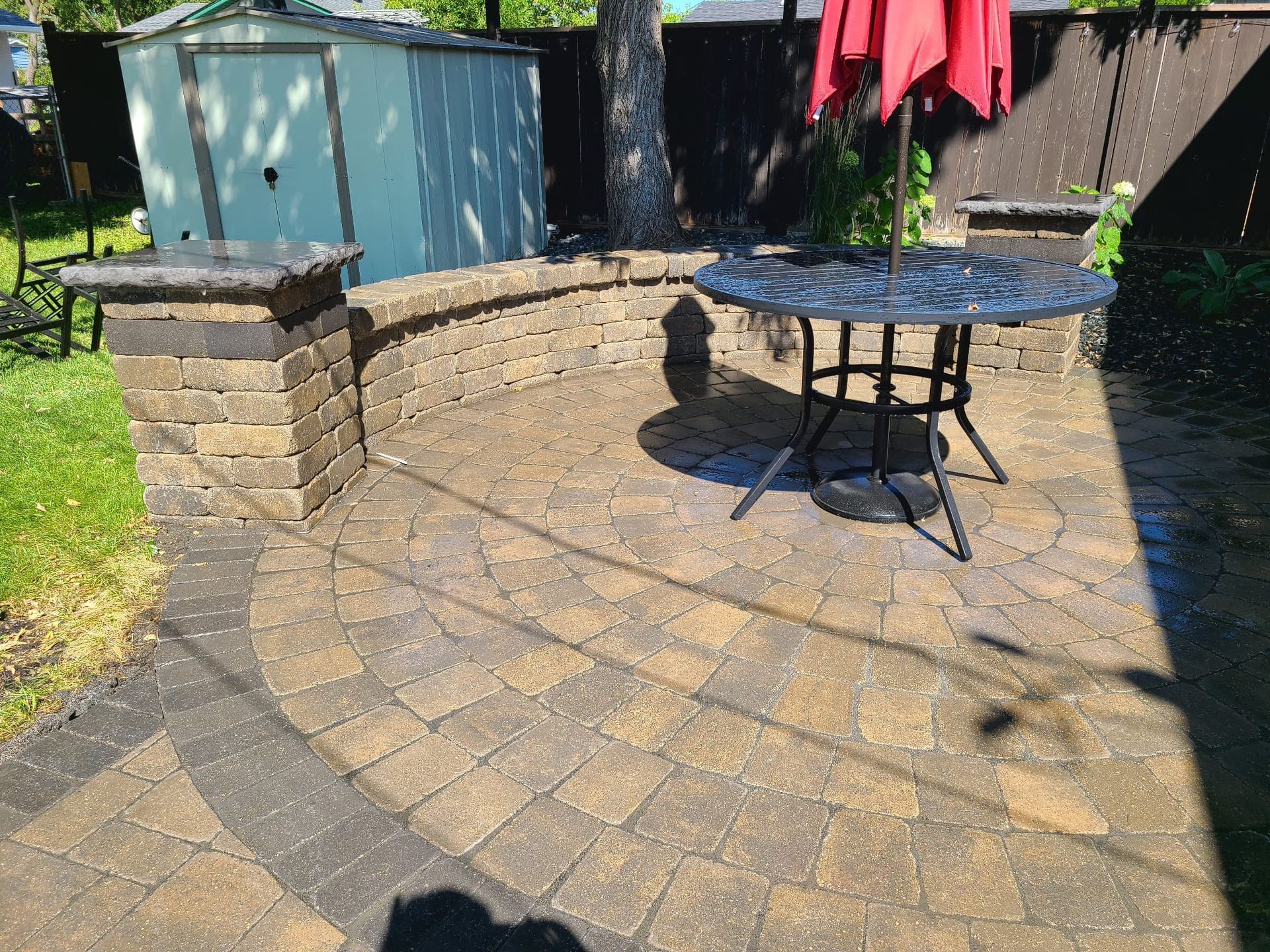 There is a table and umbrella on the patio.