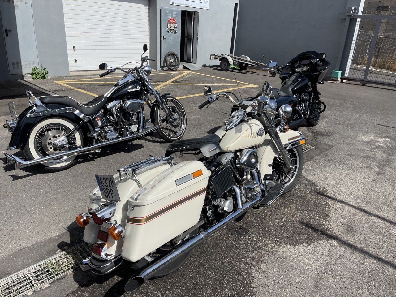 Two harley davidson motorcycles are parked in a parking lot.