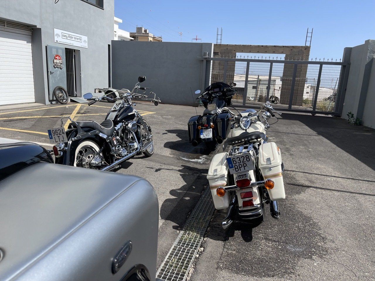 A row of motorcycles are parked in a parking lot