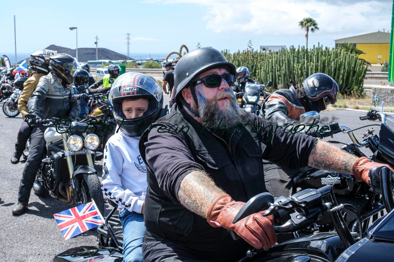 A group of people are riding motorcycles on a road.