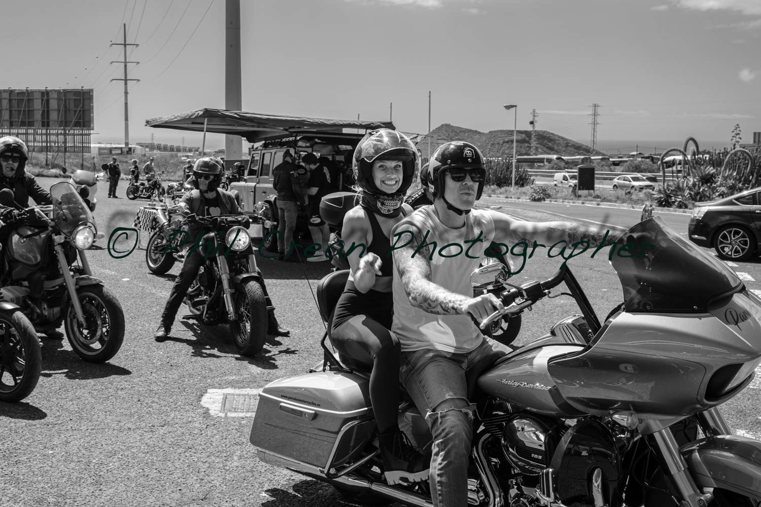 A black and white photo of a group of people riding motorcycles.