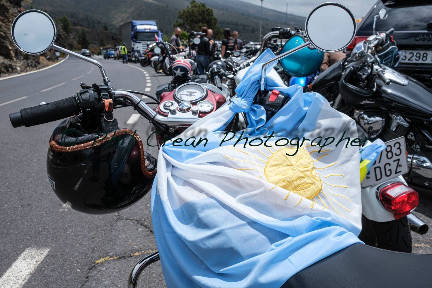 A motorcycle with an argentinian flag on the handlebars