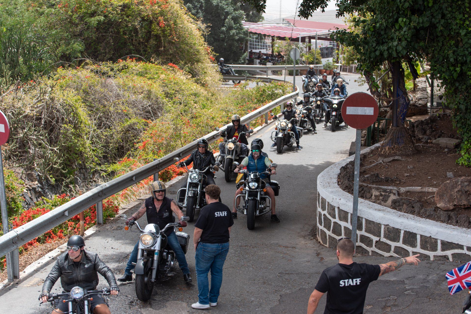 A group of people are riding motorcycles down a road.